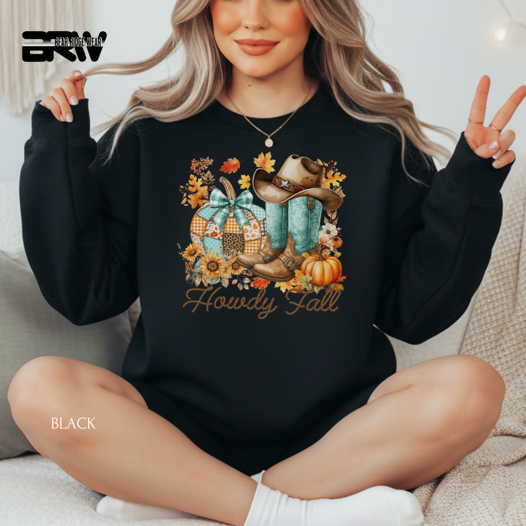 Person wearing a black sweatshirt with fall-themed design and 'Howdy Fall' text.