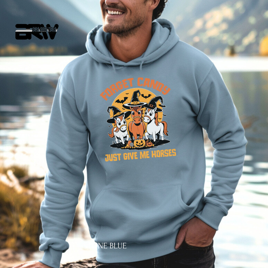 Person wearing a blue hoodie with Halloween-themed design by a lake