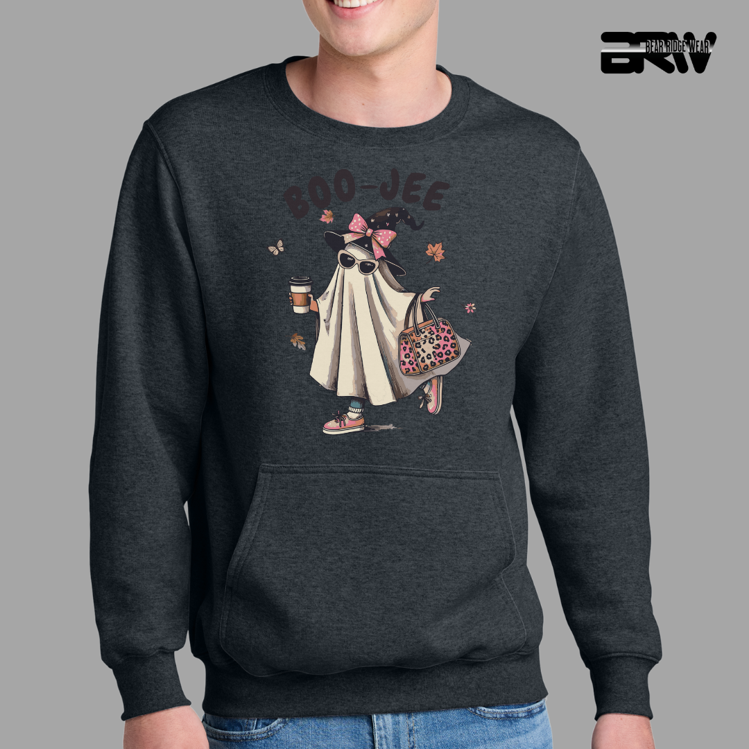 Person wearing a dark gray sweatshirt with a graphic design on a gray background