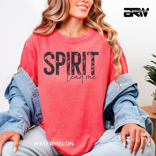 Person wearing a red shirt with 'SPIRIT lead me' text, sitting indoors.