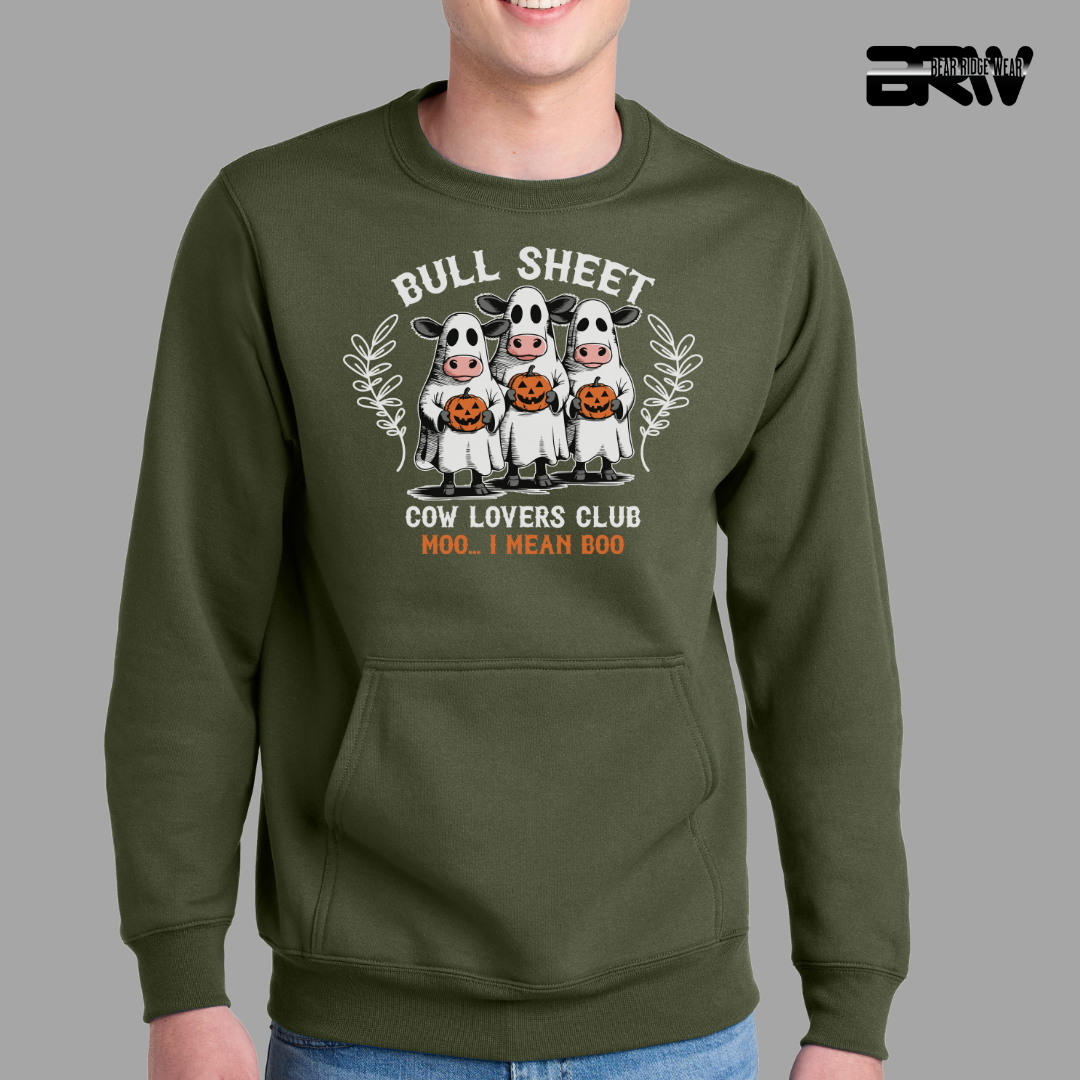 Green sweatshirt with cartoon cow design and text on a gray background