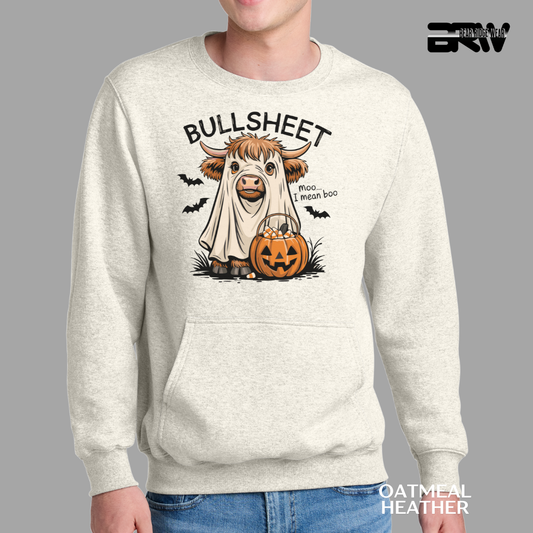 Person wearing a sweatshirt with a cartoon cow in a ghost costume and pumpkin, on a gray background.