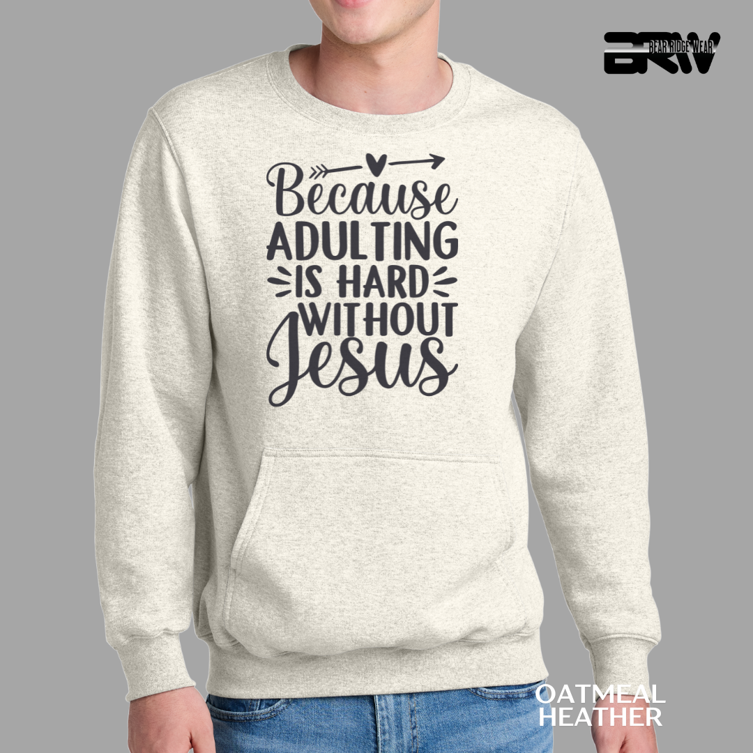 Person wearing a sweatshirt with 'Because adulting is hard without Jesus' text on a gray background