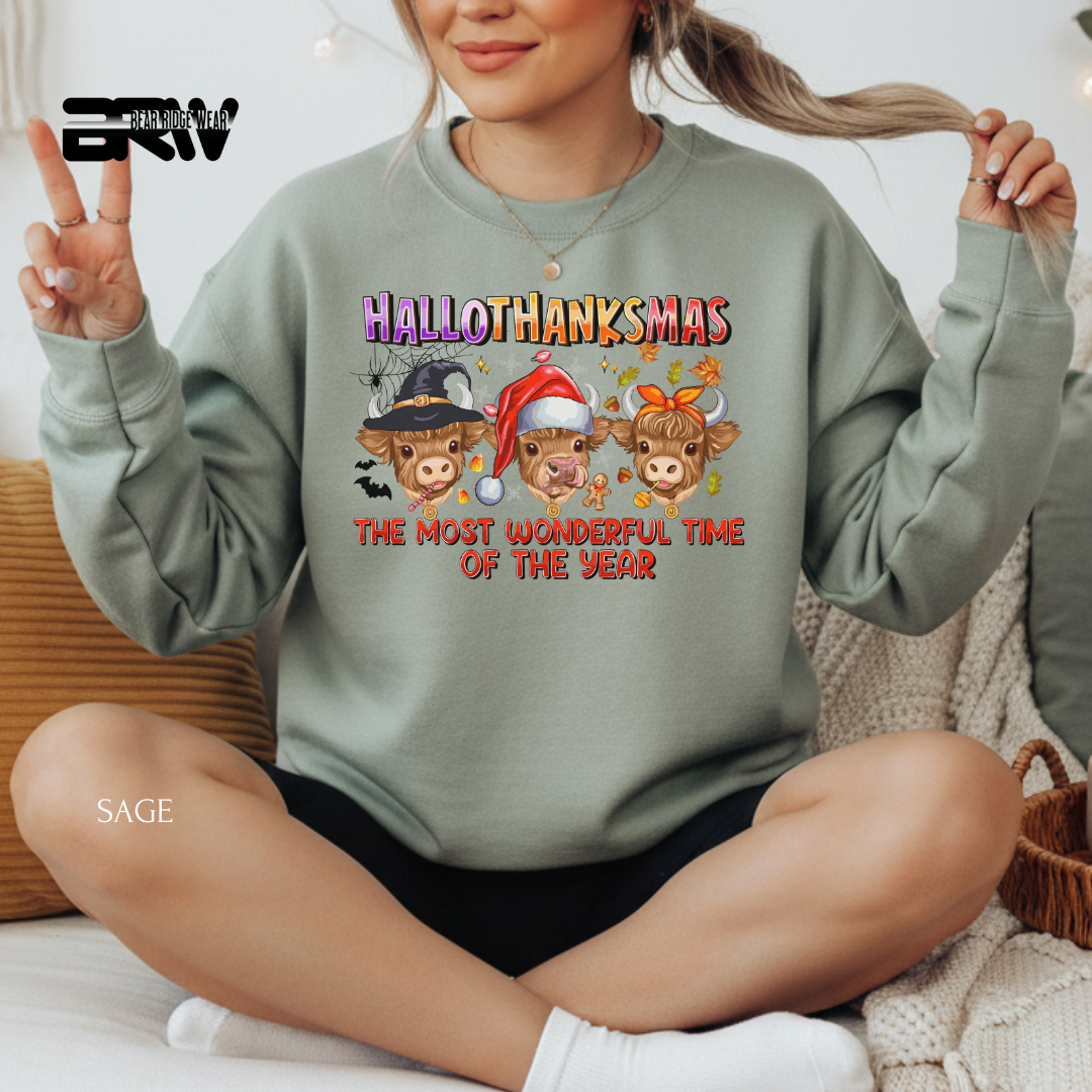 Person wearing a green sweatshirt with 'Hallothanksmas' design, sitting on a couch.