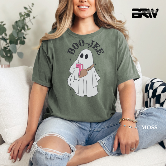 Woman wearing a green t-shirt with a ghost graphic and 'BOO-JEE' text, sitting on a couch.