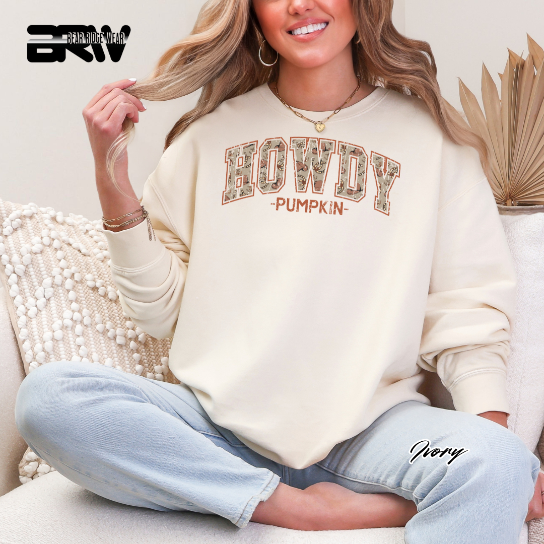 Person wearing a 'HOWDY PUMPKIN' sweatshirt sitting on a couch.