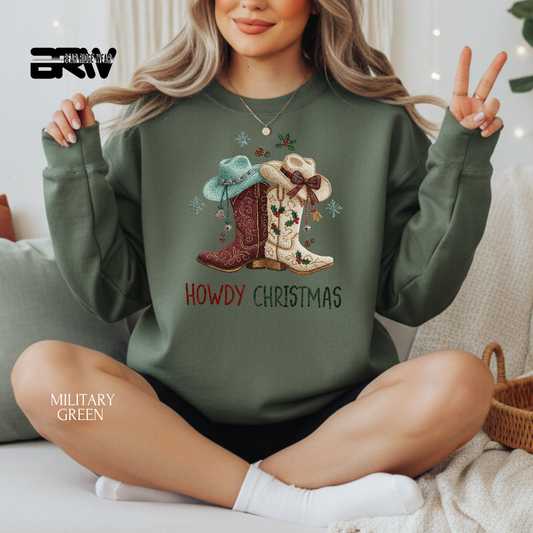 Person wearing a green sweatshirt with 'Howdy Christmas' design, sitting on a couch.