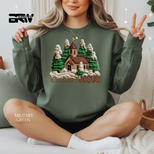 Person wearing a military green sweatshirt with a Christmas-themed design, sitting on a couch.
