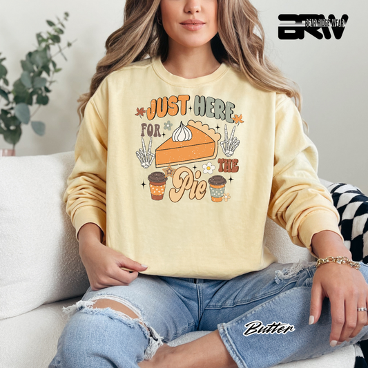Person wearing a yellow sweatshirt with a pie graphic and text, sitting on a couch.