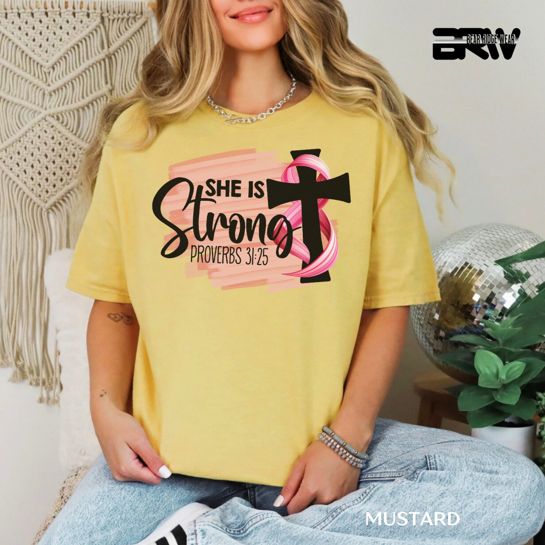 Person wearing a yellow t-shirt with a graphic design and text, sitting in a casual setting.