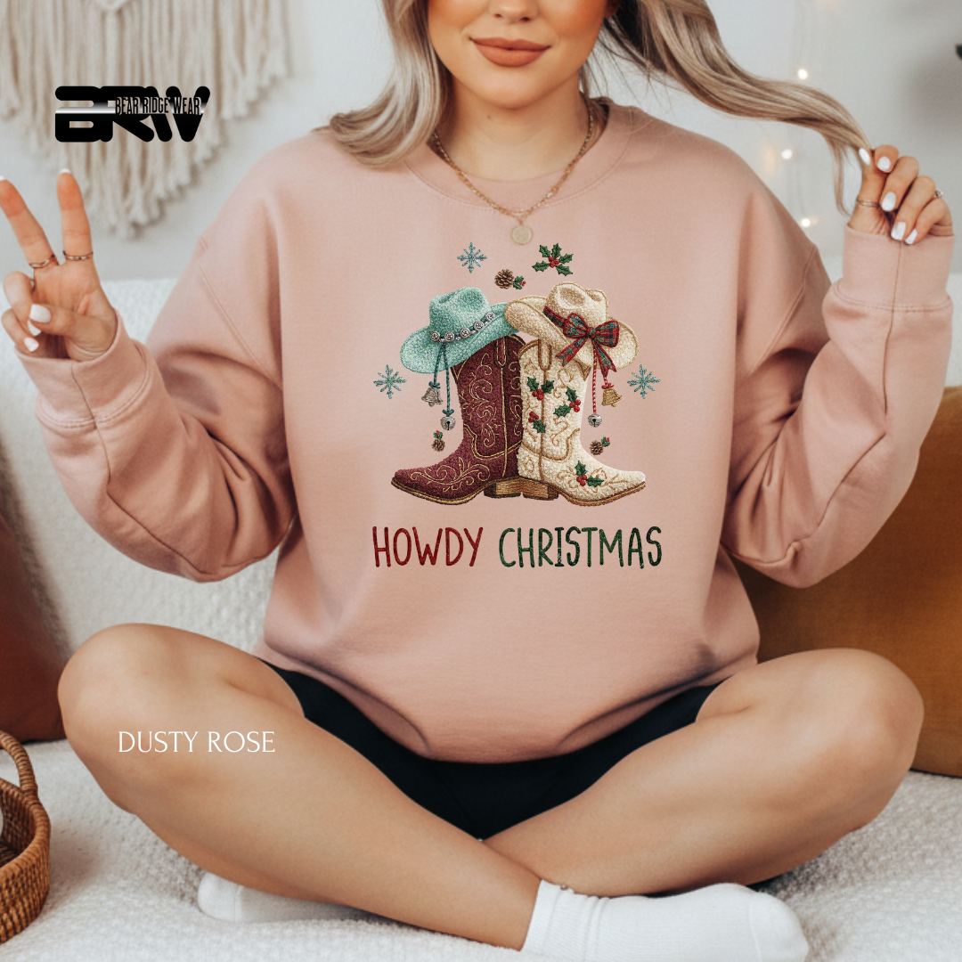 Person wearing a pink sweatshirt with Christmas-themed design and 'Howdy Christmas' text.